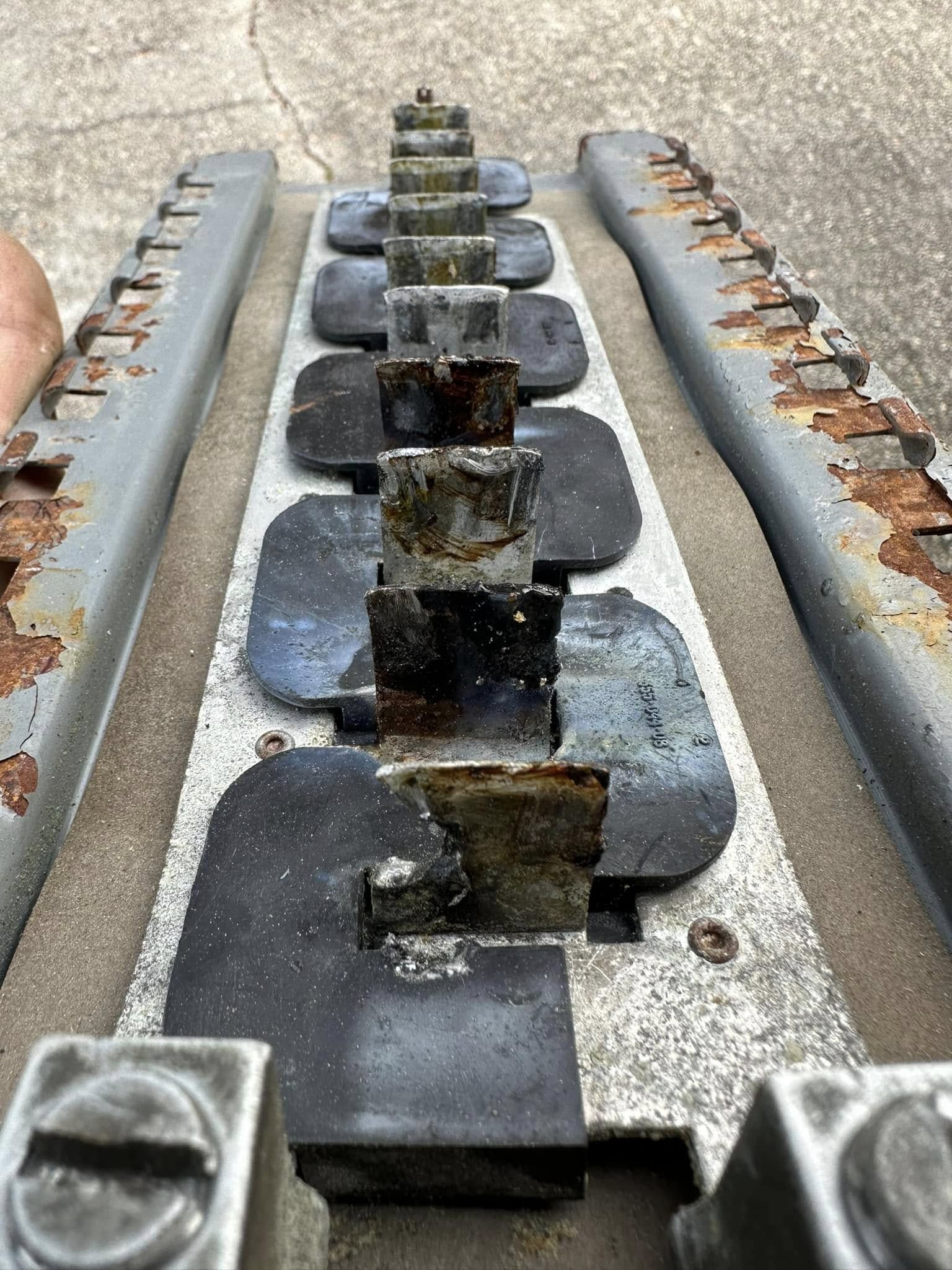 Burned-out breaker panel before replacement